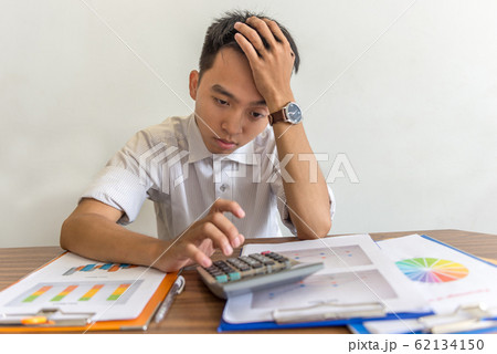 Young business employee worried about financial problem 62134150