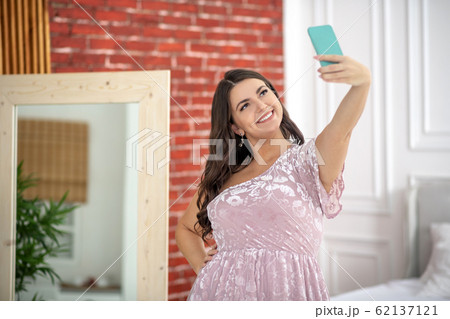 Young plus-size woman making selfie and looking amazing Young plus-size woman making selfie and looking amazing 62137121