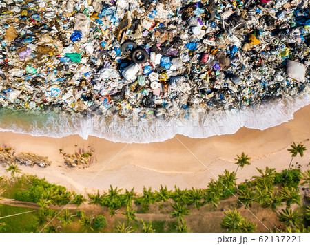 Tropical beach and trash in the water. Ocean pollution concept with plastic 62137221