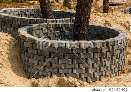 Protective brick rings around trees Protective brick rings around trees 62142401
