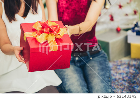 girls hand giving gift box in Christmas New year 62143345