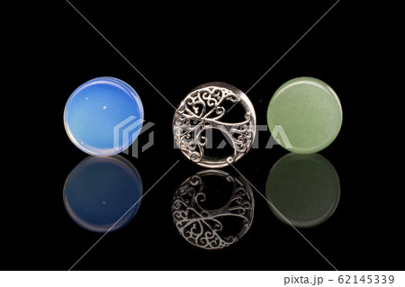 Stylish ear plug isolated on black glass Stylish ear plug isolated on black glass 62145339