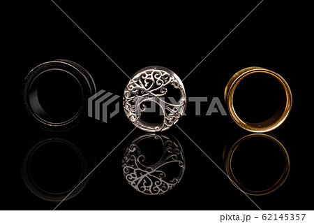 Stylish ear plug isolated on black glass 62145357