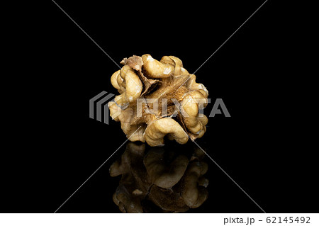Brown tasty walnut isolated on black glass Brown tasty walnut isolated on black glass 62145492