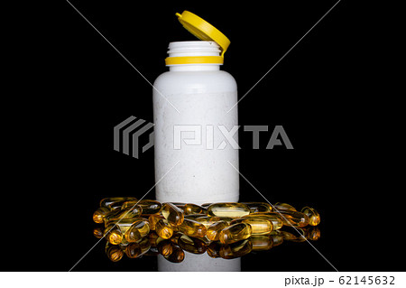 Golden fish oil isolated on black glass 62145632