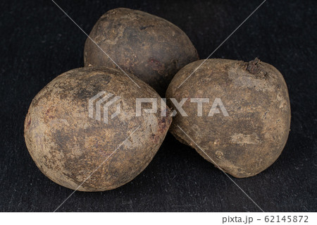 Raw sweet beetroot on grey stone 62145872