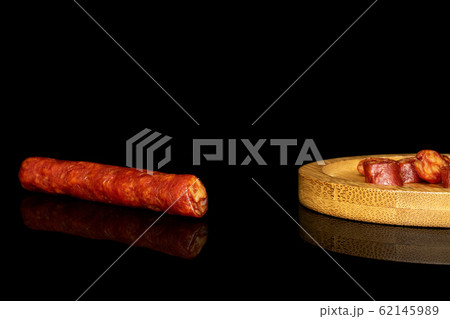 Smoked spicy sausage isolated on black glass Smoked spicy sausage isolated on black glass 62145989