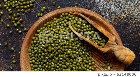 Dried mung beans with a spoon on a dark background 62148006