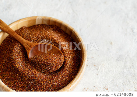 Raw teff grain in a wooden bowl close up 62148008