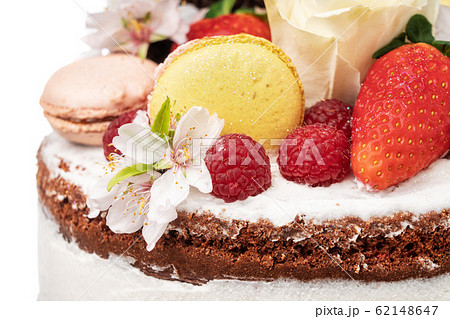Naked birthday cake with almond flower fruits and marshmallows. Close-up. 62148647