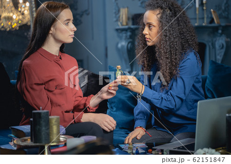 Professional healer gazing at her female patient 62151847