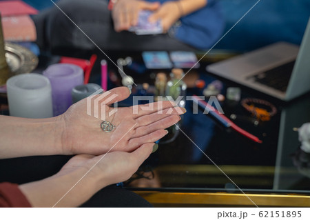 Caucasian woman sitting at a fortune-tellers session 62151895