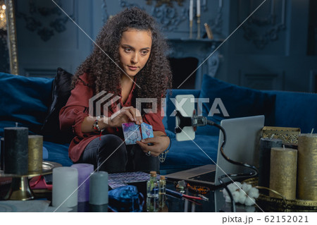 Young female fortune-teller staring at the camera 62152021