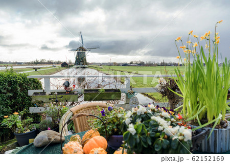 Picturesque Dutch landscape with a view of the mill through the canal with water 62152169