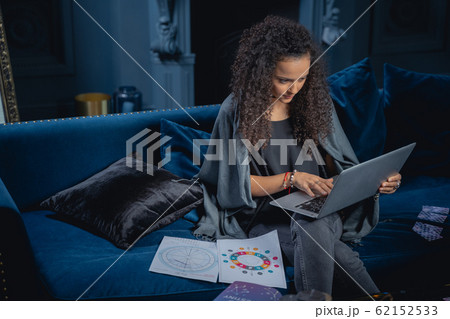 Young pretty female astrologer surfing the net 62152533