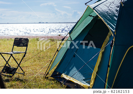 Camping green tent near lake Camping green tent near lake 62162153