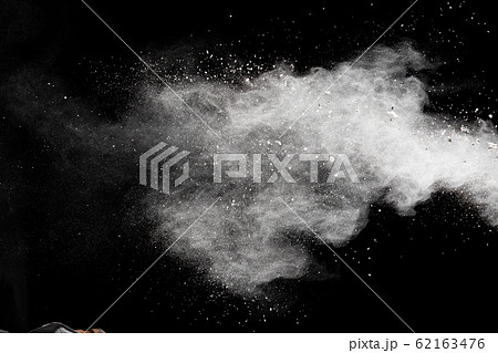 Freeze motion of white dust particles splash on black background.White powder explosion clouds. Freeze motion of white dust particles splash on black background.White powder explosion clouds. 62163476