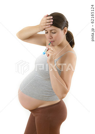 Pregnant Woman using Digital Thermometer Pregnant Woman using Digital Thermometer 62165124