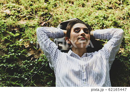 Beautiful woman sleeping relaxation on green grass Beautiful woman sleeping relaxation on green grass 62165447