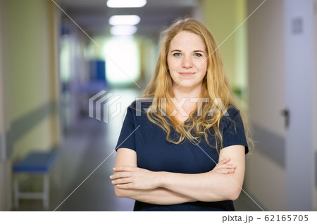 Smiling nurse in hospital hallway 62165705