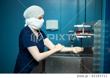 Surgeon doctor disinfects hands before surgery. Surgeon doctor disinfects hands before surgery. 62165711