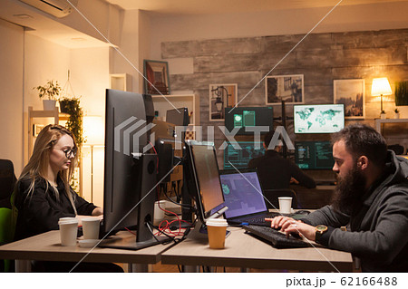 Beautiful female hacker in working together with cyber criminals 62166488