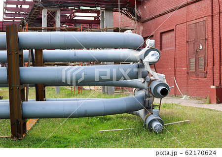 A large iron metal piping trestle with pipes  62170624