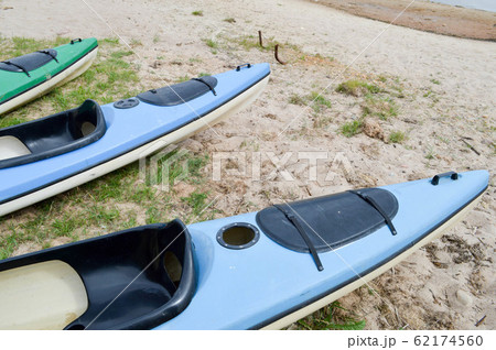 A lot of blue and green canoe kayaks 62174560