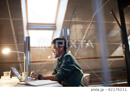 Young designer working on laptop Young designer working on laptop 62176211