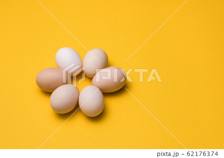 natural ecological eggs in shape of flower on yellow background with copy space. happy easter 62176374