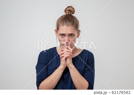 Young caucasian woman with knot is sad because of something. 62176562