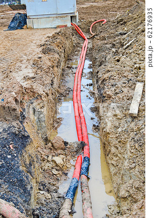 Large red plastic corrugated pipes with wires Large red plastic corrugated pipes with wires 62176935