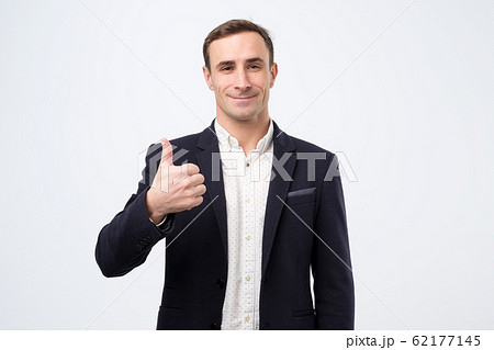 Happy mature italian man in suit with thumbs up gesture approving your choice Happy mature italian man in suit with thumbs up gesture approving your choice 62177145