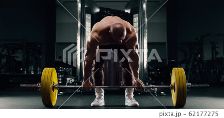 Bodybuilder athletic man back muscles deadlift 62177275