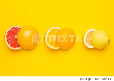 Tropical cutting citrus fruits , orange, grapefruit, lemon and lime on yellow background Tropical cutting citrus fruits , orange, grapefruit, lemon and lime on yellow background 62178233