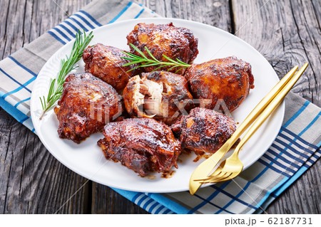 roasted Chicken thighs on a white plate 62187731