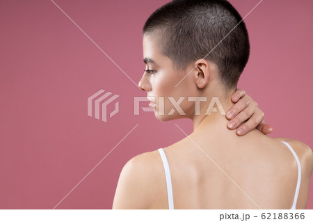 Thoughtful lady touching the back of her neck stock photo 62188366