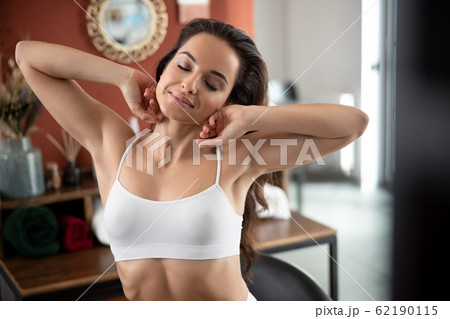 Beautiful young woman is stretching after awake 62190115