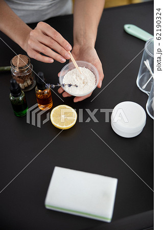 Young lady preparing cosmetic clay for mask Young lady preparing cosmetic clay for mask 62190324