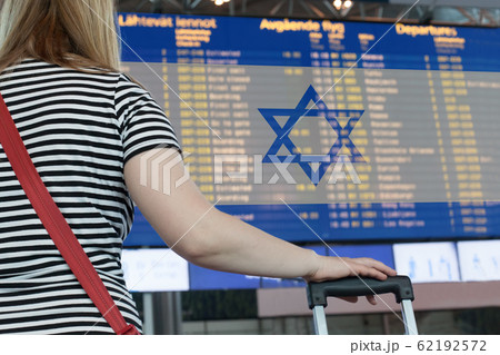 Woman looks at the scoreboard at the airport. Woman looks at the scoreboard at the airport. 62192572