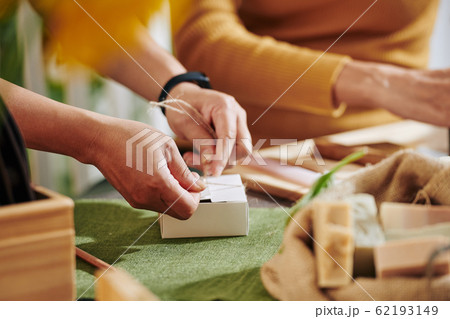Women packing small soap bars Women packing small soap bars 62193149