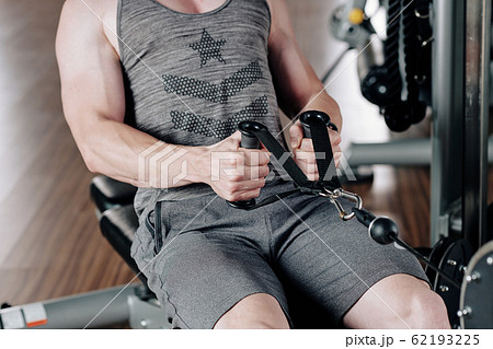 Man exercising in rowing machine Man exercising in rowing machine 62193225