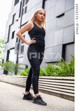 Confident Attractive Athletic Woman Standing Against Building In City 62195004
