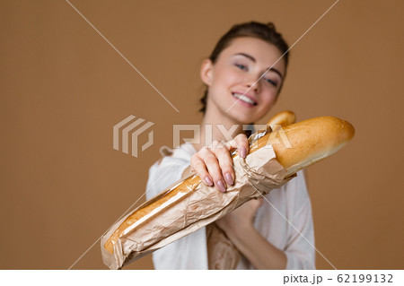 young woman holding bread 62199132