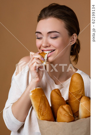 young woman holding bread 62199134