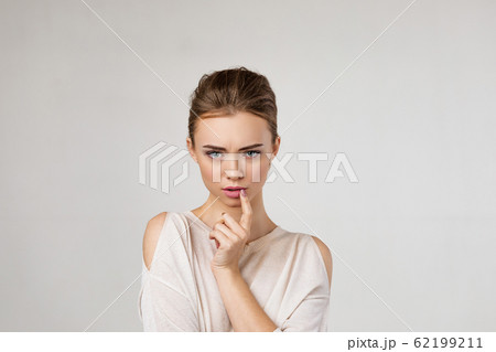 Portrait of cute brunette woman thinking about something 62199211