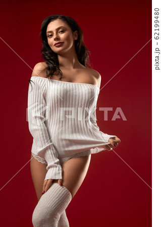 Smiling model posing in sweater. Smiling model posing in sweater. 62199480