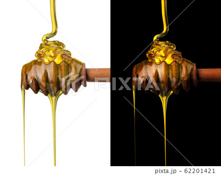 Honey on a wooden dipper isolated on black and white background Honey on a wooden dipper isolated on black and white background 62201421
