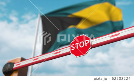 Closed boom gate on the Bahamian flag background. Restricted entry or certain ban in Bahamas. 3D rendering Closed boom gate on the Bahamian flag background. Restricted entry or certain ban in Bahamas. 3D rendering 62202224