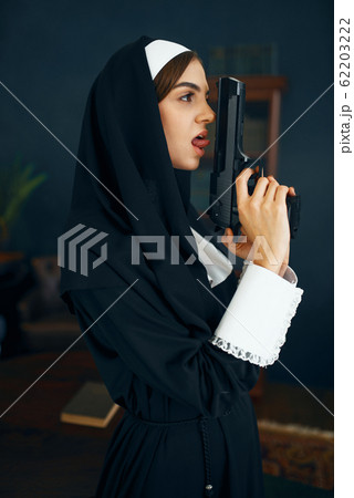 Nun in a cassock holds a gun, vicious desires 62203222